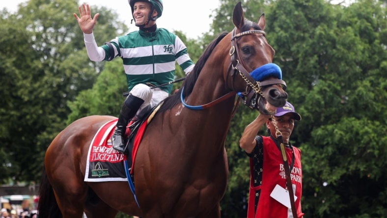 Jun 11, 2022; Elmont, NY, USA; Flightline   s jockey Flavien Prat waves to the crowd as they leave the Paddock before The Hill    N    Dale Metropolitan race at Belmont Park Racetrack. Mandatory Credit: Jessica Alcheh-USA TODAY Sports