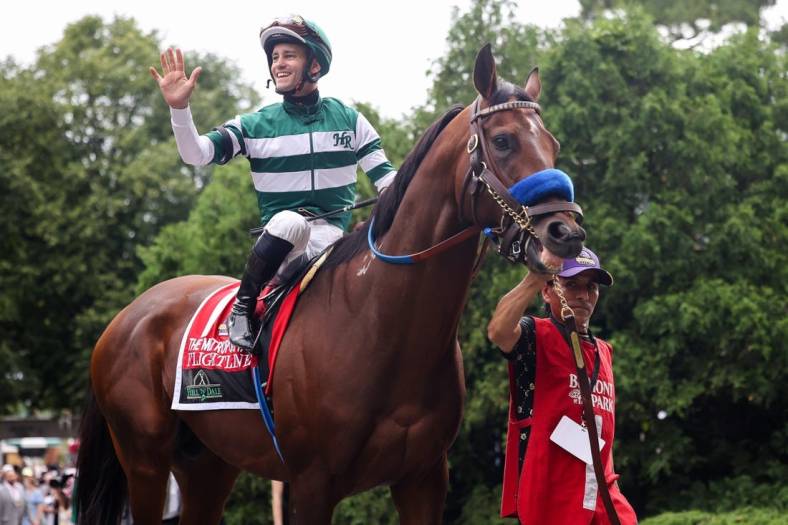 Jun 11, 2022; Elmont, NY, USA; Flightline   s jockey Flavien Prat waves to the crowd as they leave the Paddock before The Hill    N    Dale Metropolitan race at Belmont Park Racetrack. Mandatory Credit: Jessica Alcheh-USA TODAY Sports