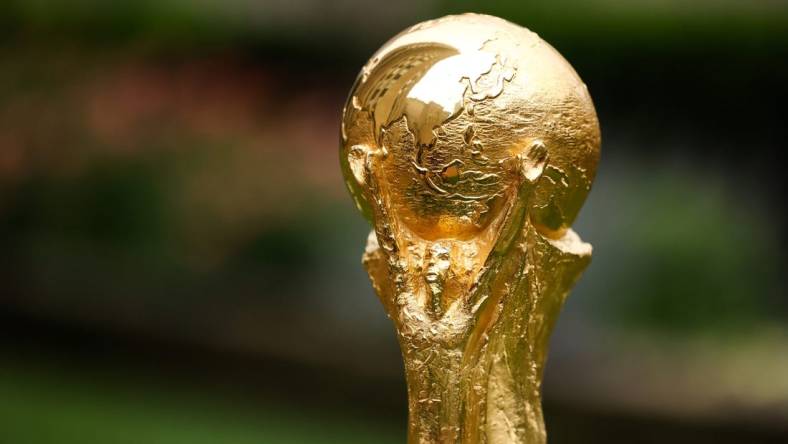 Jun 16, 2022; New York, New York, USA; A detail view of The FIFA World Cup Trophy sits on a stand outside of 30 Rockefeller Plaza.  Mandatory Credit: Jessica Alcheh-USA TODAY Sports