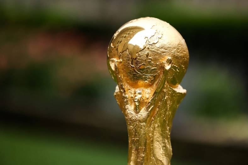 Jun 16, 2022; New York, New York, USA; A detail view of The FIFA World Cup Trophy sits on a stand outside of 30 Rockefeller Plaza.  Mandatory Credit: Jessica Alcheh-USA TODAY Sports