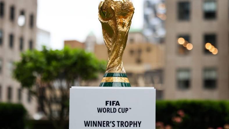 Jun 16, 2022; New York, New York, USA; The FIFA World Cup Trophy sits on a stand outside of 30 Rockefeller Plaza.  Mandatory Credit: Jessica Alcheh-USA TODAY Sports