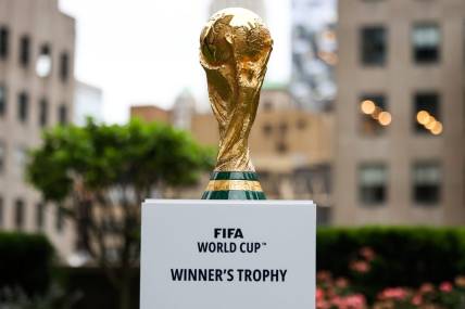 Jun 16, 2022; New York, New York, USA; The FIFA World Cup Trophy sits on a stand outside of 30 Rockefeller Plaza.  Mandatory Credit: Jessica Alcheh-USA TODAY Sports