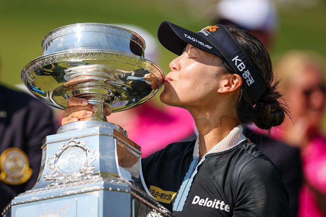 Jun 26, 2022; Bethesda, Maryland, USA; In Gee Chun kisses the trophy after wining the KPMG Women's PGA Championship golf tournament at Congressional Country Club. Mandatory Credit: Scott Taetsch-USA TODAY Sports