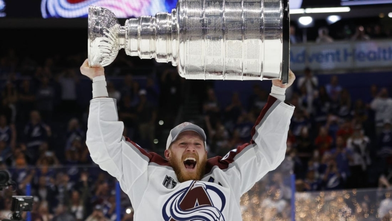 Jun 26, 2022; Tampa, Florida, USA; Colorado Avalanche left wing Gabriel Landeskog (92) celebrates with the Stanley Cup after the game against the Tampa Bay Lightning in game six of the 2022 Stanley Cup Final at Amalie Arena. Mandatory Credit: Geoff Burke-USA TODAY Sports