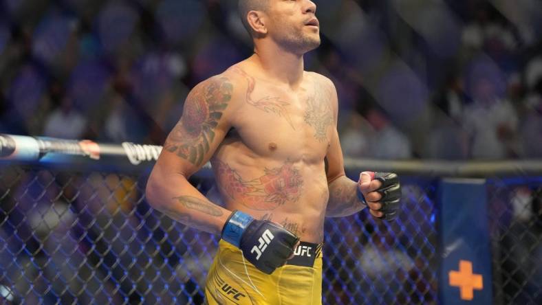 Jul 2, 2022; Las Vegas, Nevada, USA; Alex Pereira (blue gloves) enters the octagon before a bout against Sean Strickland (red gloves) during UFC 276 at T-Mobile Arena. Mandatory Credit: Stephen R. Sylvanie-USA TODAY Sports