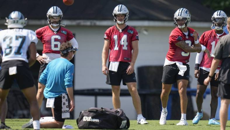 Jul 28, 2022; Spartanburg, SC, USA; Carolina Panthers quarterback Baker Mayfield (6), quarterback Sam Darnold (14), and quarterback PJ Walker (11) watch quarterback Matt Corral (9) during the third day of training camp at Wofford College. Mandatory Credit: Jim Dedmon-USA TODAY Sports