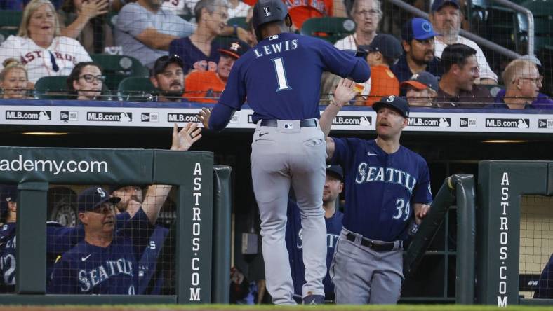 Jul 30, 2022; Houston, Texas, USA; Seattle Mariners designated hitter Kyle Lewis (1) celebrates in the dugout after scoring a run during the first inning against the Houston Astros at Minute Maid Park. Mandatory Credit: Troy Taormina-USA TODAY Sports