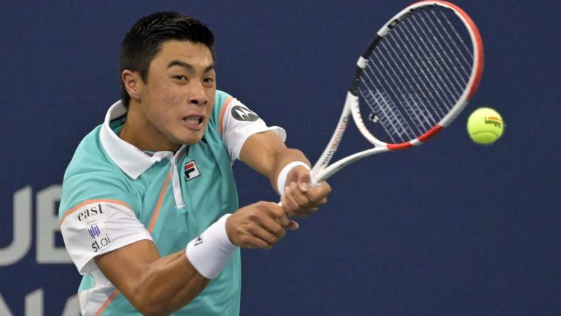 Aug 9, 2022; Montreal, QC, Canada; Brandon Nakashima (USA) hits a backhand against Cameron Norrie (GBR) (not pictured) in first round play in the National Bank Open at IGA Stadium. Mandatory Credit: Eric Bolte-USA TODAY Sports