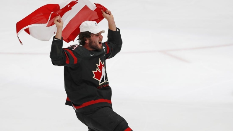 Aug 20, 2022; Edmonton, Alberta, CAN; Team Canada forward Mason MacTavish (23) celebrates with a Canadian flag after winning the gold medal in the championship game during the IIHF U20 Ice Hockey World Championship at Rogers Place. Mandatory Credit: Perry Nelson-USA TODAY Sports