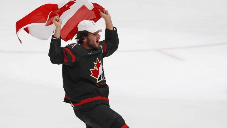 Aug 20, 2022; Edmonton, Alberta, CAN; Team Canada forward Mason MacTavish (23) celebrates with a Canadian flag after winning the gold medal in the championship game during the IIHF U20 Ice Hockey World Championship at Rogers Place. Mandatory Credit: Perry Nelson-USA TODAY Sports