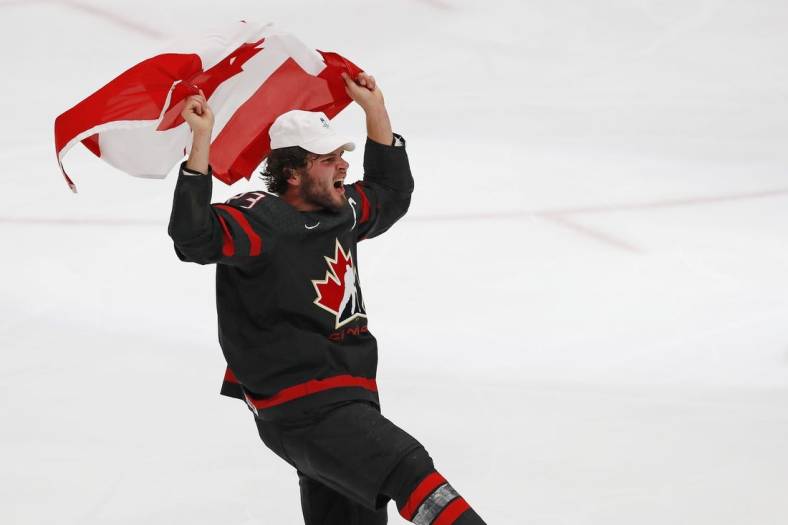 Aug 20, 2022; Edmonton, Alberta, CAN; Team Canada forward Mason MacTavish (23) celebrates with a Canadian flag after winning the gold medal in the championship game during the IIHF U20 Ice Hockey World Championship at Rogers Place. Mandatory Credit: Perry Nelson-USA TODAY Sports
