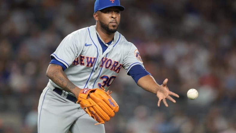 Aug 23, 2022; Bronx, New York, USA; New York Mets relief pitcher Joely Rodriguez (30) tosses the ball to first base for an out during the seventh inning against the New York Yankees at Yankee Stadium. Mandatory Credit: Vincent Carchietta-USA TODAY Sports