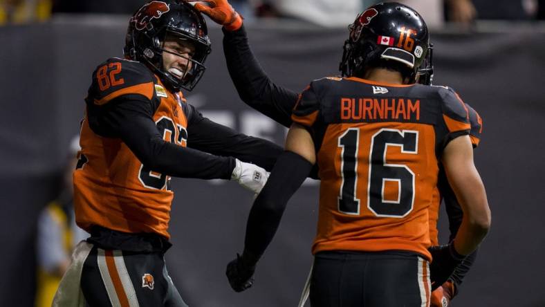 Aug 26, 2022; Vancouver, British Columbia, CAN; BC Lions wide receiver Jacob Scarfone (82) celebrates his touchdown with wide receiver Bryan Burnham (16) in the second half against the Saskatchewan Roughriders at BC Place. Mandatory Credit: Bob Frid-USA TODAY Sports