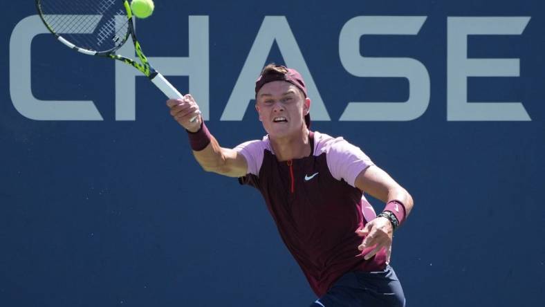 Aug 30, 2022; Flushing, NY, USA; Holger Rune of Denmark hits a shot against Peter Gojowczyk of Germany on day two of the 2022 U.S. Open tennis tournament at USTA Billie Jean King National Tennis Center. Mandatory Credit: Jerry Lai-USA TODAY Sports