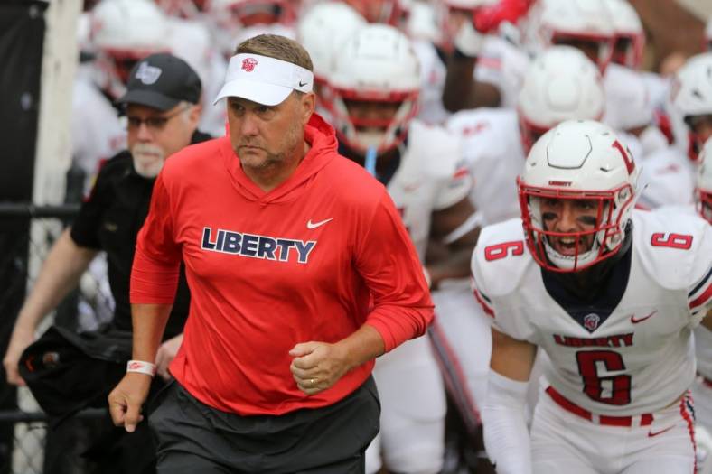 Sep 3, 2022; Hattiesburg, Mississippi, USA; Liberty Flames head coach Hugh Freeze run onto the field before their game against the Southern Miss Golden Eagles at M.M. Roberts Stadium. Mandatory Credit: Chuck Cook-USA TODAY Sports
