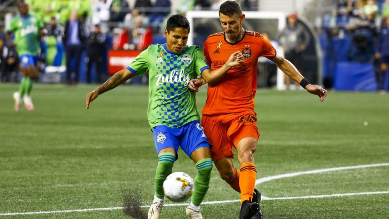 Sep 4, 2022; Seattle, Washington, USA; Houston Dynamo defender Daniel Steres (2) clears a ball in the box away from Seattle Sounders FC forward Raul Ruidiaz (9) during the second half at Lumen Field. Mandatory Credit: Joe Nicholson-USA TODAY Sports