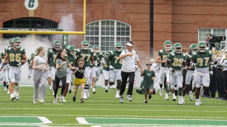Sep 10, 2022; Charlotte, North Carolina, USA; Charlotte 49ers head coach Will Healy and friends take the field during the first quarter against the Maryland Terrapins at Jerry Richardson Stadium. Mandatory Credit: Jim Dedmon-USA TODAY Sports
