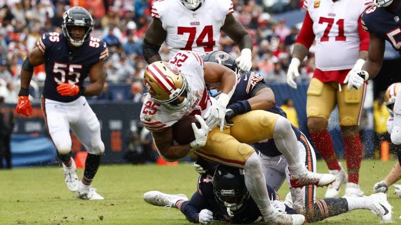 Sep 11, 2022; Chicago, Illinois, USA; San Francisco 49ers running back Elijah Mitchell (25) rushes the ball against Chicago Bears safety Jaquan Brisker (9) during the first half at Soldier Field. Mandatory Credit: Mike Dinovo-USA TODAY Sports