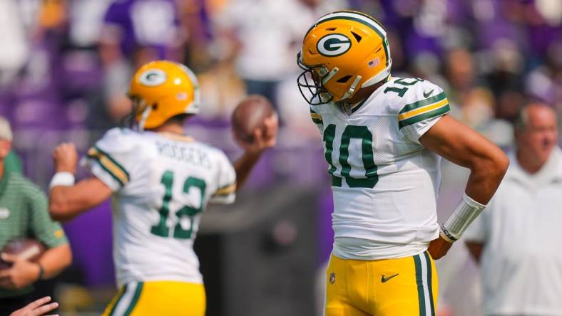 Sep 11, 2022; Minneapolis, Minnesota, USA; Green Bay Packers quarterback Jordan Love (10) watches quarterback Aaron Rodgers (12) warm up before the game against the Minnesota Vikings at U.S. Bank Stadium. Mandatory Credit: Brad Rempel-USA TODAY Sports