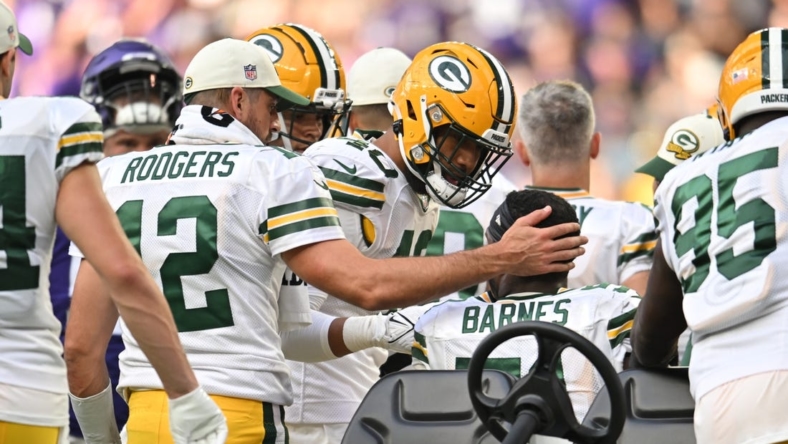 Sep 11, 2022; Minneapolis, Minnesota, USA; Green Bay Packers quarterback Aaron Rodgers (12) and linebacker Tipa Galeai (40) react with linebacker Krys Barnes (51) who was injured against the Minnesota Vikings during the fourth quarter at U.S. Bank Stadium. Mandatory Credit: Jeffrey Becker-USA TODAY Sports