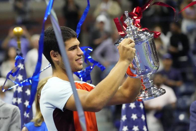 Sep 11, 2022; Flushing, NY, USA; Carlos Alcaraz (ESP) celebrates with the championship trophy after his match against Casper Ruud (NOR) (not pictured) in the men's singles final on day fourteen of the 2022 U.S. Open tennis tournament at USTA Billie Jean King Tennis Center. Mandatory Credit: Robert Deutsch-USA TODAY Sports