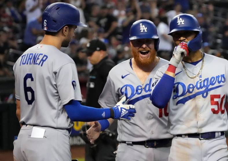 Sep 12, 2022; Phoenix, Arizona, USA; Los Angeles Dodgers second Mookie Betts (50) celebrates with Los Angeles Dodgers designated hitter Justin Turner (10) and Los Angeles Dodgers shortstop Trea Turner (6) after hitting a two run home run against the Arizona Diamondbacks during the ninth inning at Chase Field. Mandatory Credit: Joe Camporeale-USA TODAY Sports