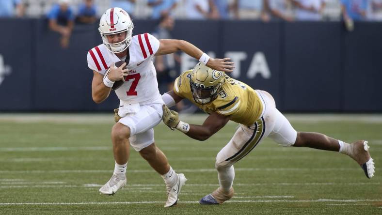 Sep 17, 2022; Atlanta, Georgia, USA; Mississippi Rebels quarterback Luke Altmyer (7) runs past Georgia Tech Yellow Jackets defensive lineman Kyle Kennard (9) in the second half at Bobby Dodd Stadium. Mandatory Credit: Brett Davis-USA TODAY Sports