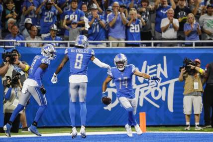 Sep 18, 2022; Detroit, Michigan, USA;  Detroit Lions wide receiver Amon-Ra St. Brown (14) celebrates a touchdown against the Washington Commanders   with teammates wide receiver Josh Reynolds (8) and wide receiver DJ Chark (4) during the first half at Ford Field. Mandatory Credit: Junfu Han-USA TODAY Sports
