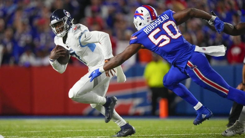 Sep 19, 2022; Orchard Park, New York, USA; Tennessee Titans quarterback Malik Willis (7) scrambles with Buffalo Bills defensive end Greg Rousseau (50) defending during the second half at Highmark Stadium. Mandatory Credit: Gregory Fisher-USA TODAY Sports