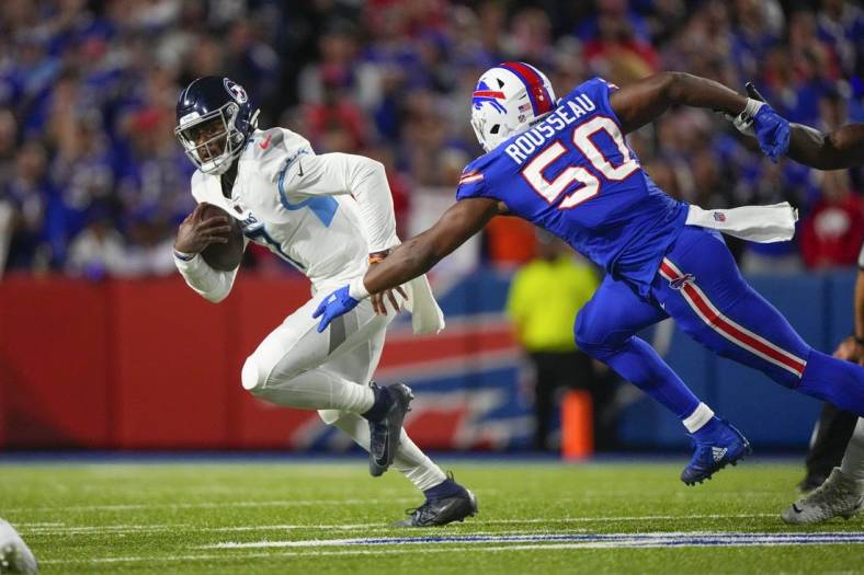 Sep 19, 2022; Orchard Park, New York, USA; Tennessee Titans quarterback Malik Willis (7) scrambles with Buffalo Bills defensive end Greg Rousseau (50) defending during the second half at Highmark Stadium. Mandatory Credit: Gregory Fisher-USA TODAY Sports