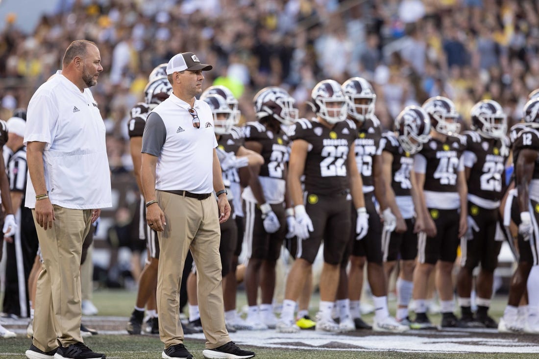 Sep 17, 2022; Kalamazoo, Michigan, USA; Western Michigan Broncos head coach Tim Lester (middle) and defensive coordinator Lou Esposito (left) watch pregame warm ups against Pittsburgh Panthers at Waldo Stadium. Mandatory Credit: Kimberly Moss-USA TODAY Sports