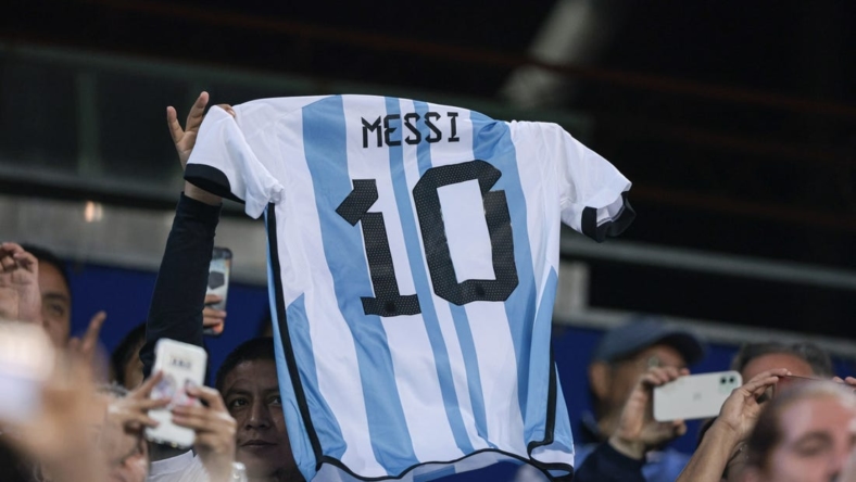 Sep 27, 2022; Harrison, New Jersey, USA; Argentina fans hold the jersey of forward Lionel Messi (not pictured) during the second half against Jamaica at Red Bull Arena. Mandatory Credit: Vincent Carchietta-USA TODAY Sports
