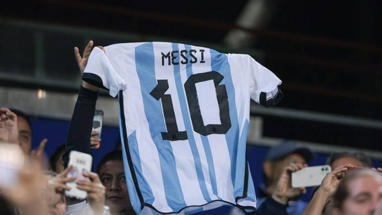 Sep 27, 2022; Harrison, New Jersey, USA; Argentina fans hold the jersey of forward Lionel Messi (not pictured) during the second half against Jamaica at Red Bull Arena. Mandatory Credit: Vincent Carchietta-USA TODAY Sports