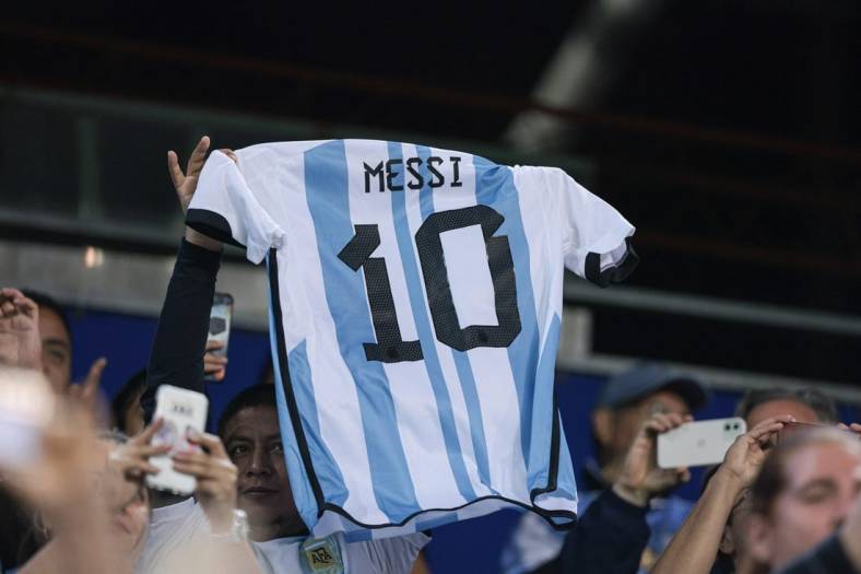 Sep 27, 2022; Harrison, New Jersey, USA; Argentina fans hold the jersey of forward Lionel Messi (not pictured) during the second half against Jamaica at Red Bull Arena. Mandatory Credit: Vincent Carchietta-USA TODAY Sports