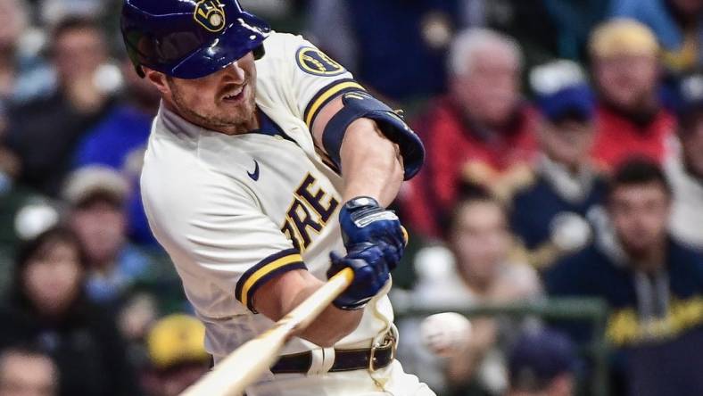 Sep 28, 2022; Milwaukee, Wisconsin, USA; Milwaukee Brewers right fielder Hunter Renfroe (12) hits an RBI single in the third inning against the St. Louis Cardinals at American Family Field. Mandatory Credit: Benny Sieu-USA TODAY Sports