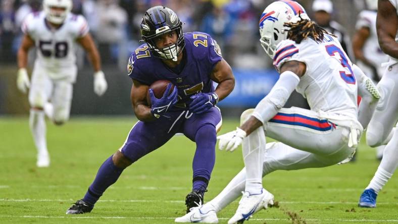 Oct 2, 2022; Baltimore, Maryland, USA;  Baltimore Ravens running back J.K. Dobbins (27) cuts in front of Buffalo Bills safety Damar Hamlin (3) during the second quarter at M&T Bank Stadium. Mandatory Credit: Tommy Gilligan-USA TODAY Sports