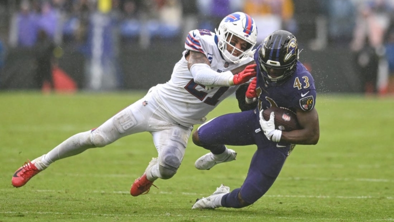Oct 2, 2022; Baltimore, Maryland, USA;  Baltimore Ravens running back Justice Hill (43) is tackled by Buffalo Bills safety Jordan Poyer (21) during the second half at M&T Bank Stadium. Mandatory Credit: Tommy Gilligan-USA TODAY Sports