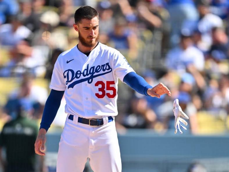 Oct 2, 2022; Los Angeles, California, USA; Los Angeles Dodgers center fielder Cody Bellinger (35) tosses his batting gloves after striking out in the fifth inning against the Colorado Rockies at Dodger Stadium. Mandatory Credit: Jayne Kamin-Oncea-USA TODAY Sports