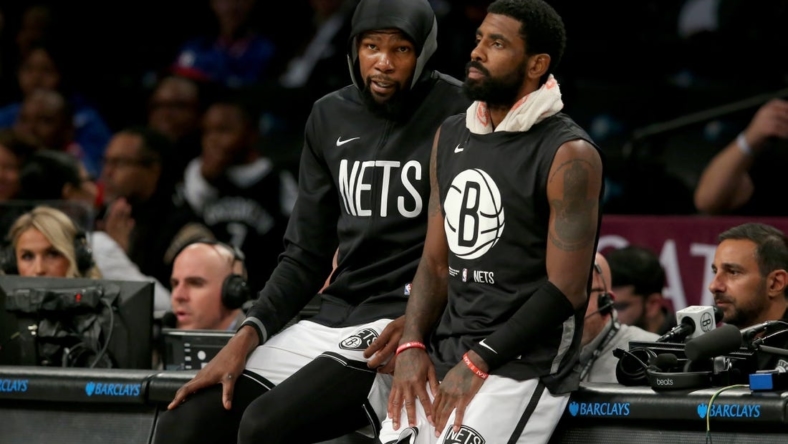 Oct 3, 2022; Brooklyn, New York, USA; Brooklyn Nets forward Kevin Durant (7) and guard Kyrie Irving (11) wait to check into the game against the Philadelphia 76ers during the second quarter at Barclays Center. Mandatory Credit: Brad Penner-USA TODAY Sports