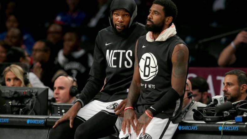 Oct 3, 2022; Brooklyn, New York, USA; Brooklyn Nets forward Kevin Durant (7) and guard Kyrie Irving (11) wait to check into the game against the Philadelphia 76ers during the second quarter at Barclays Center. Mandatory Credit: Brad Penner-USA TODAY Sports