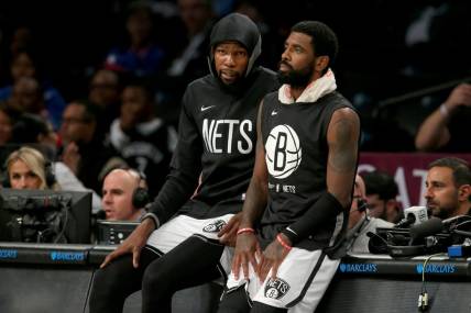 Oct 3, 2022; Brooklyn, New York, USA; Brooklyn Nets forward Kevin Durant (7) and guard Kyrie Irving (11) wait to check into the game against the Philadelphia 76ers during the second quarter at Barclays Center. Mandatory Credit: Brad Penner-USA TODAY Sports