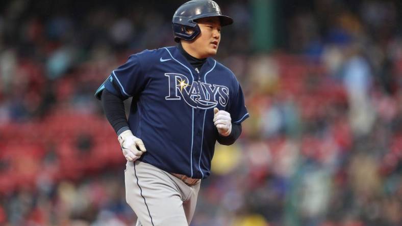 Oct 5, 2022; Boston, Massachusetts, USA; Tampa Bay Rays first baseman Ji-Man Choi (26) hits a home run during the third inning against the Boston Red Sox at Fenway Park. Mandatory Credit: Paul Rutherford-USA TODAY Sports