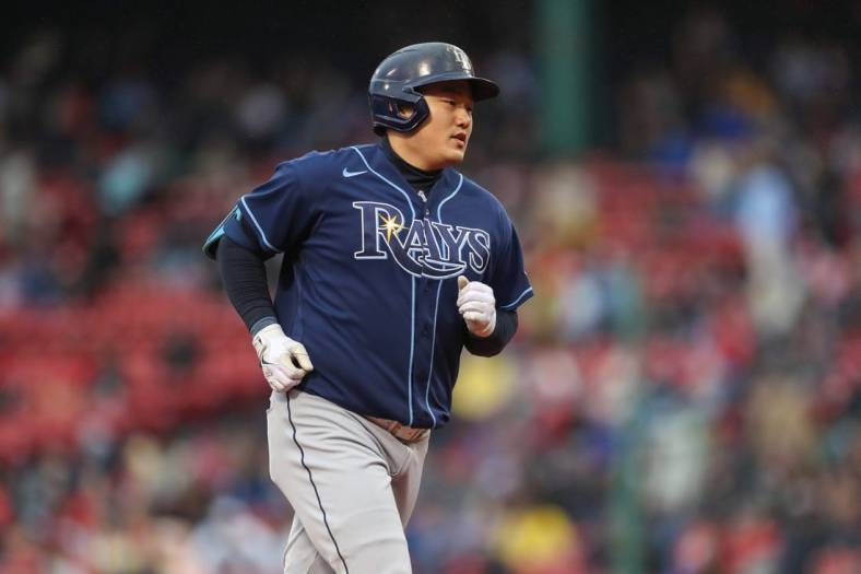Oct 5, 2022; Boston, Massachusetts, USA; Tampa Bay Rays first baseman Ji-Man Choi (26) hits a home run during the third inning against the Boston Red Sox at Fenway Park. Mandatory Credit: Paul Rutherford-USA TODAY Sports