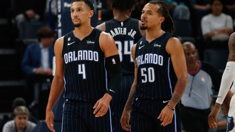 Oct 3, 2022; Memphis, Tennessee, USA; Orlando Magic guard Jalen Suggs (4) and guard Cole Anthony (50) walk to the bench during a timeout during the first half against the Memphis Grizzlies at FedExForum. Mandatory Credit: Petre Thomas-USA TODAY Sports