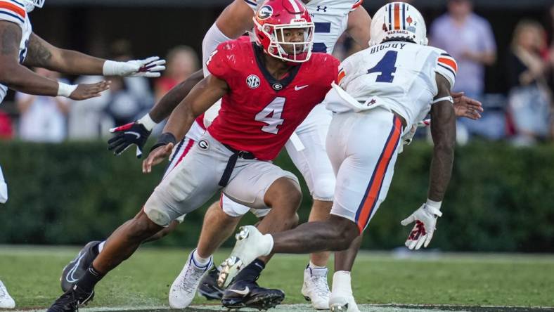 Oct 8, 2022; Athens, Georgia, USA; Georgia Bulldogs linebacker Nolan Smith (4) tackles Auburn Tigers running back Tank Bigsby (4) at Sanford Stadium. Mandatory Credit: Dale Zanine-USA TODAY Sports