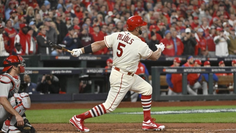 Oct 8, 2022; St. Louis, Missouri, USA; St. Louis Cardinals designated hitter Albert Pujols (5) hits a single in the eighth inning against the Philadelphia Phillies during game two of the Wild Card series for the 2022 MLB Playoffs at Busch Stadium. Mandatory Credit: Jeff Curry-USA TODAY Sports