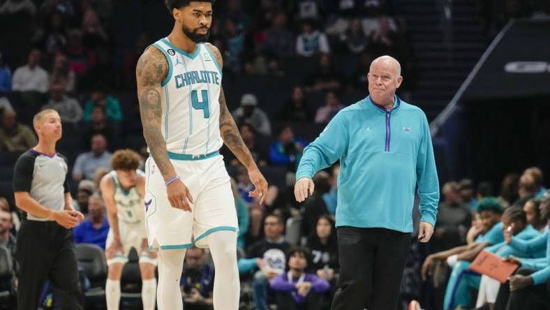 Oct 10, 2022; Charlotte, North Carolina, USA; Charlotte Hornets head coach Steve Clifford fist bumps center Nick Richards (4) after his fourth foul during the second half against the Washington Wizards at Spectrum Center. Mandatory Credit: Jim Dedmon-USA TODAY Sports