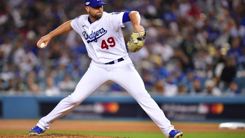 Oct 12, 2022; Los Angeles, California, USA; Los Angeles Dodgers relief pitcher Blake Treinen (49) throws during the eighth inning of game two of the NLDS for the 2022 MLB Playoffs against the San Diego Padres at Dodger Stadium. Mandatory Credit: Gary A. Vasquez-USA TODAY Sports