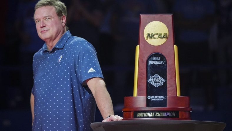 Oct 14, 2022; Lawrence, Kansas, US; Kansas Jayhawks head coach Bill Self stands next to the 2022 NCAA National Championship Trophy during Late Night at the Phog at Allen Fieldhouse. Mandatory Credit: Jay Biggerstaff-USA TODAY Sports