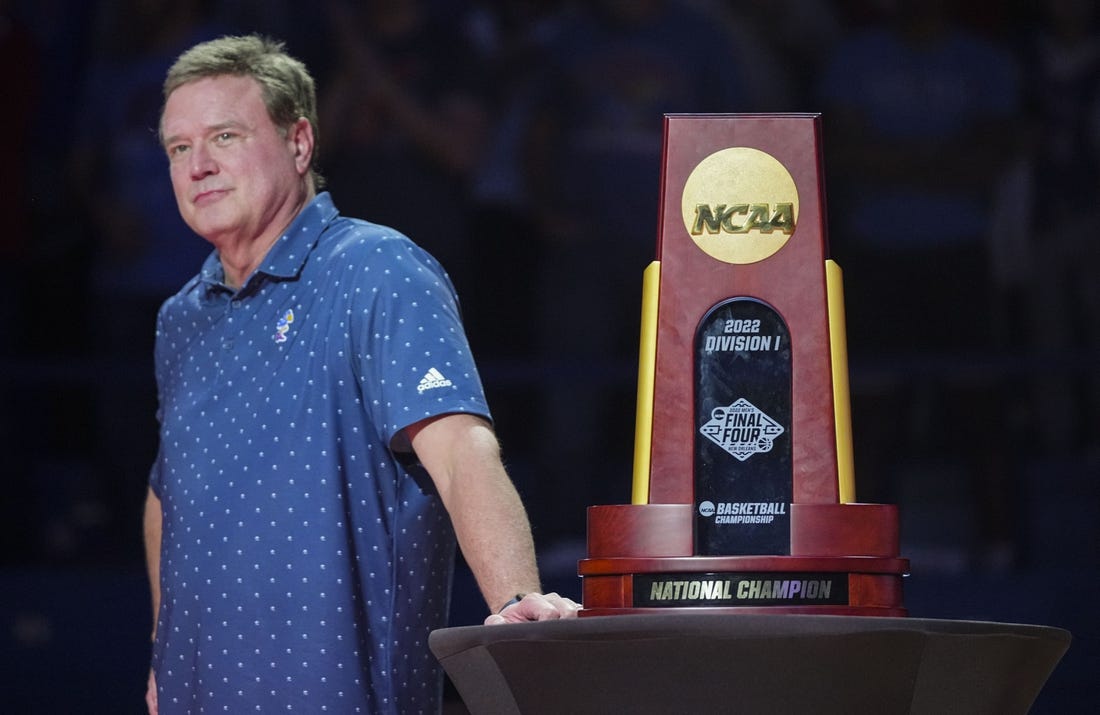 Oct 14, 2022; Lawrence, Kansas, US; Kansas Jayhawks head coach Bill Self stands next to the 2022 NCAA National Championship Trophy during Late Night at the Phog at Allen Fieldhouse. Mandatory Credit: Jay Biggerstaff-USA TODAY Sports